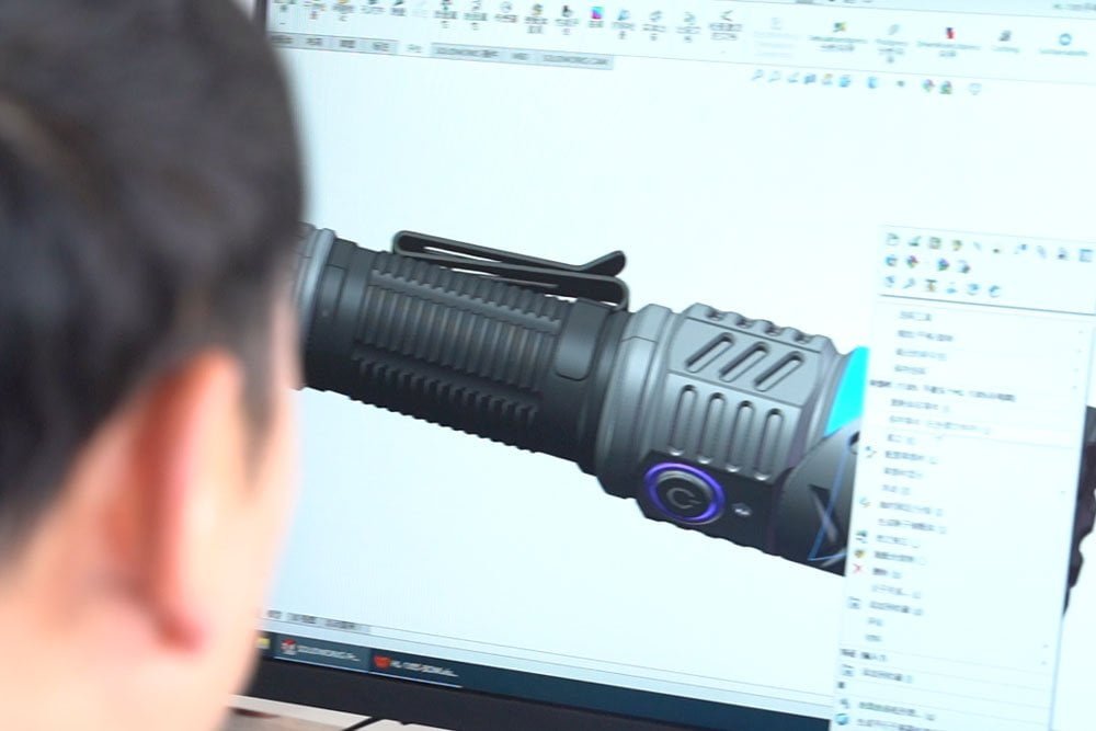 R&D team discussing flashlight design Kovalite factory team discussion