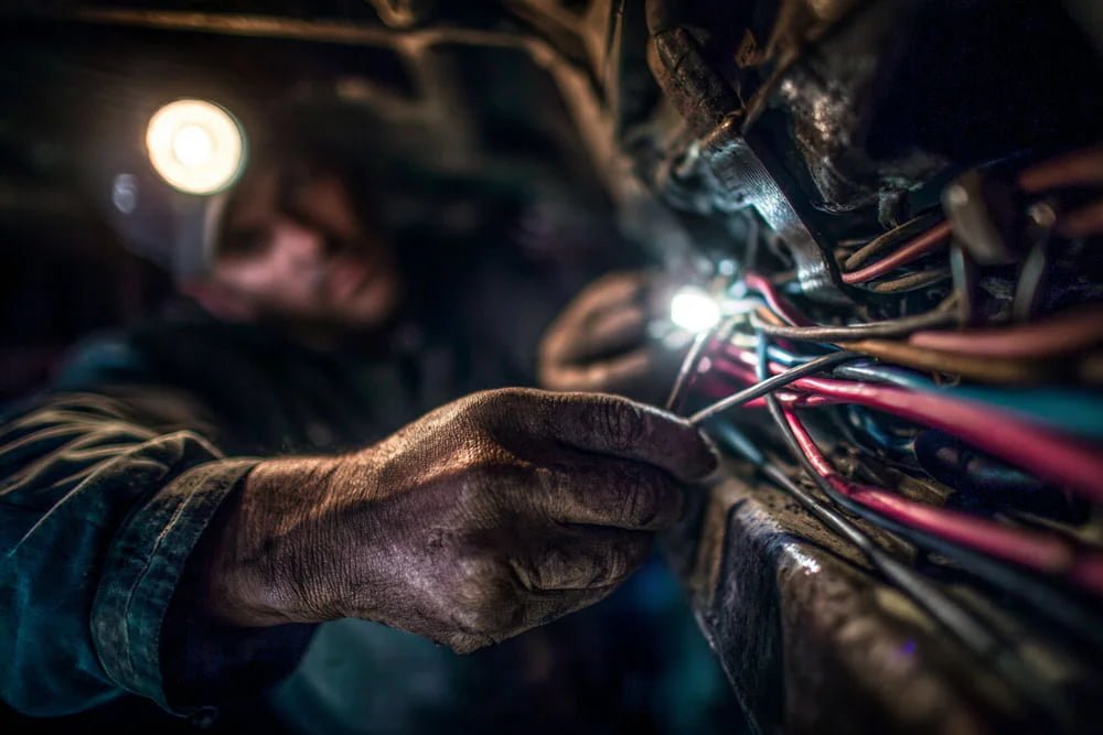 Mechanic using headlamp Mechanic working under a car with headlamp