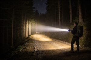 How does beam distance affect flashlight performance?
