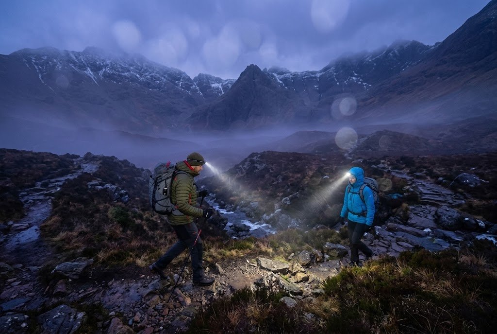 family hiking with headlamps in a light rain